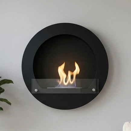 Round black wall-mounted bioethanol fireplace in a bright Scandinavian living room, lit flame