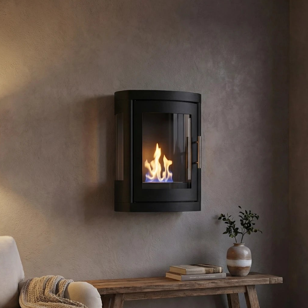 A black wall-mounted fireplace with a glass front and visible flame, installed on a textured gray wall above a wooden console table with books and a small plant.