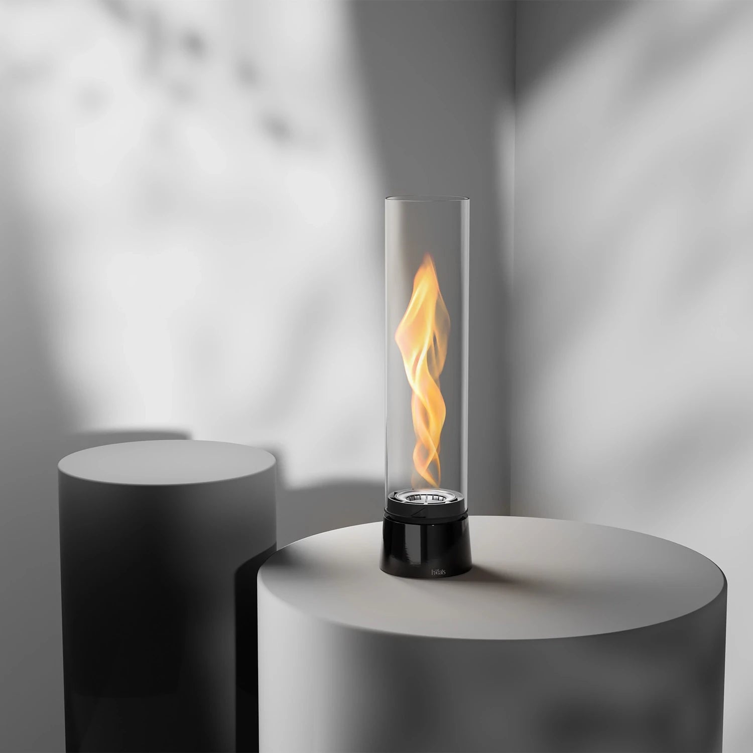 Höfats SPIN Air 1200 - Black tabletop bioethanol fireplace with tall cylindrical glass.
